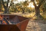 Close-up detail of hexagonal corten steel fire pit showing rust patina and welded edges
