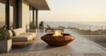 Modern minimalist terrace with sea view, glass railing, and Corten Diamond Octagon TOP outdoor fire pit.