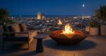 Luxury Diamond Octagon TOP outdoor fire pit on a rooftop terrace at night in Barcelona, with illuminated city skyline and ambient lighting.